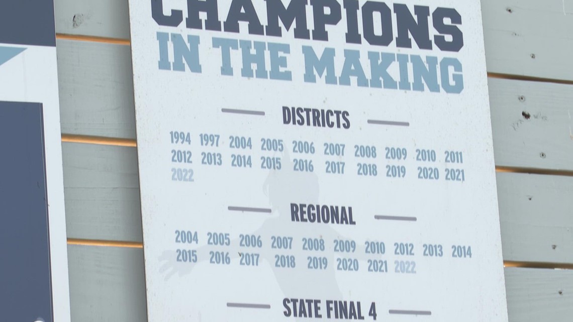 A member of the varsity team helps coach a former high school team